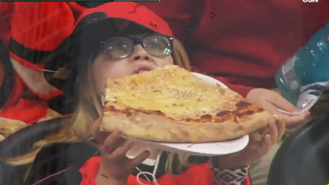 Flyers fan eating huge slice of pizza